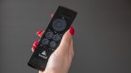 Hand holding a Lousol remote control for motorized pergola louvers, zip screens and LED lights.